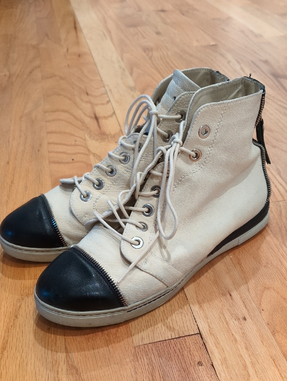 Stuart Weitzman Zipit cream and black leather high-top sneakers.